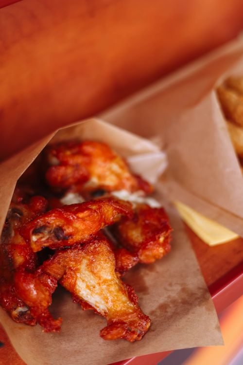 Basket of crispy chicken wings and fries, perfect for game day sharing at Roma Pizza Donair